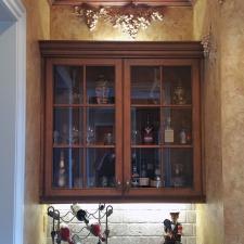 Brentwood customer’s butler’s pantry converted into a stunning Bourbon and wine room with Tuscan plaster walls sculpted grapes motifs and faux copper ceiling
